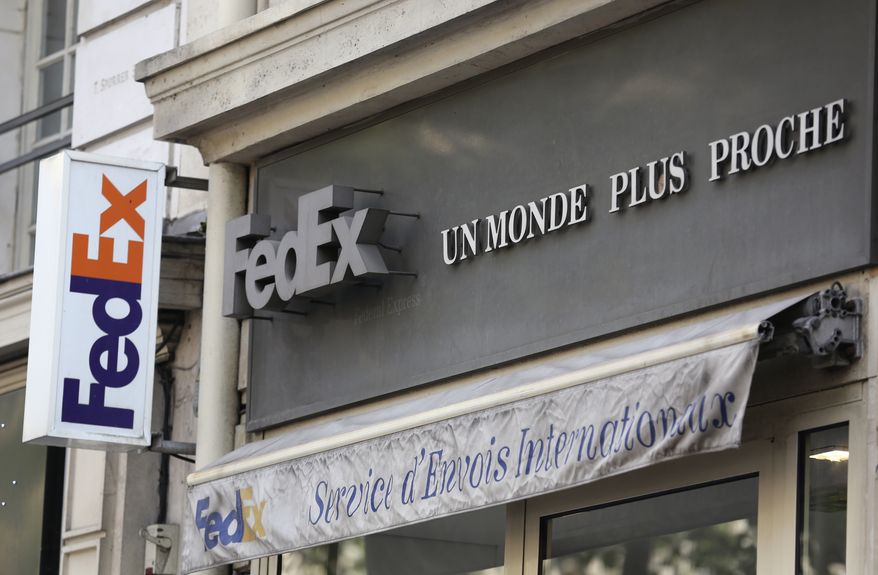 ** FILE ** The Fedex delivery company logo at the office of the Haussmann boulevard in Paris, Wednesday July 16, 2014. (AP Photo/Remy de la Mauviniere)