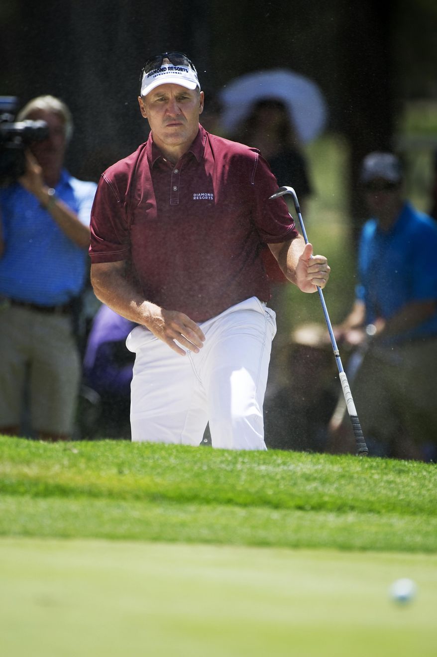 Former NFL quarterback Mark Rypien hits the ball out of the bunker during the American Century Championship golf tournament Sunday, July 20, 2014, at Edgewood Tahoe Golf Course in Stateline, Nev. (AP Photo/Reno Gazette-Journal, Hilary Swift)