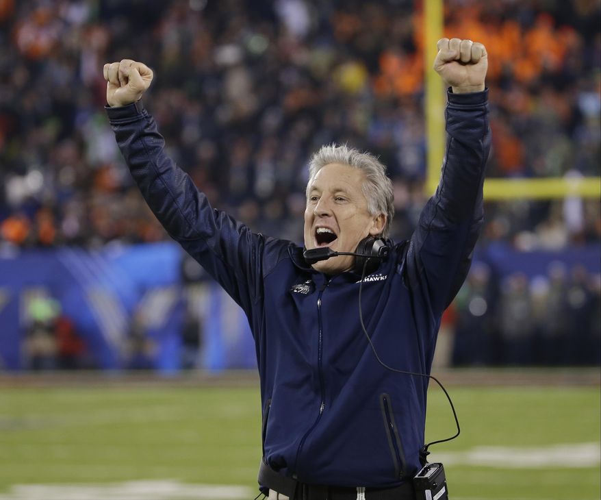 FILe - In this Feb. 2, 2014 file photo, Seattle Seahawks head coach Pete Carroll reacts as Percy Harvin returns a kickoff for a touchdown during the second half of the NFL Super Bowl XLVIII football game against the Denver Broncos in East Rutherford, N.J. Seattle begins training camp on Friday with a roster that is mostly the same as the one which raised the championship trophy last February in New Jersey. (AP Photo/Matt Slocum, File)