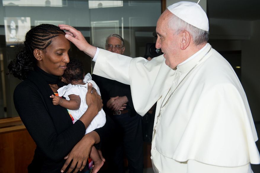 In this photo provided by the Vatican newspaper L'Osservatore Romano, Pope Francis meets Meriam Ibrahim, from Sudan, with her daughter Maya in her arms, in his Santa Marta residence, at the Vatican, Thursday, July 24, 2014. The Sudanese woman who was sentenced to death in Sudan for refusing to recant her Christian faith has arrived in Italy along with her family, including the infant born in prison. Ibrahim, whose father was Muslim but whose mother was an Orthodox Christian from Ethiopia, was sentenced to death over charges of apostasy. She married her husband, a Christian, in a church ceremony in 2011. (AP Photo/L'Osservatore Romano, File)