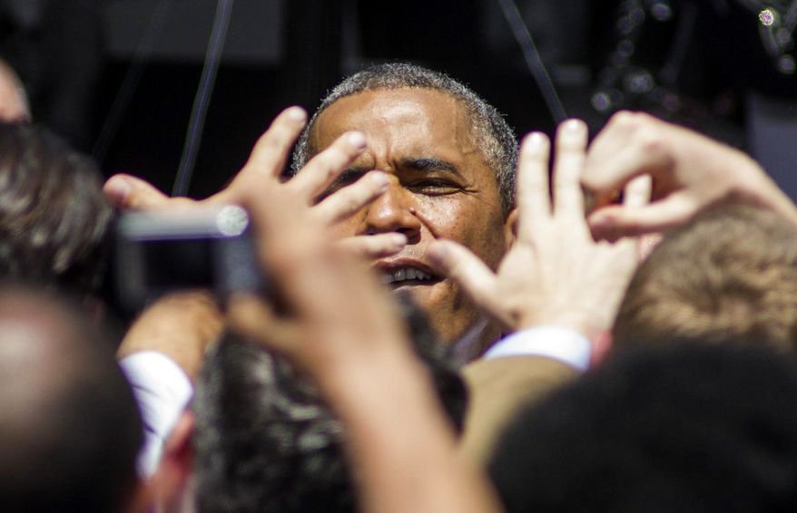 President Barack Obama greets with supporters at Los Angeles Trade-Technical College in Los Angeles on Thursday, July 24, 2014. (AP Photo/Ringo H.W. Chiu)