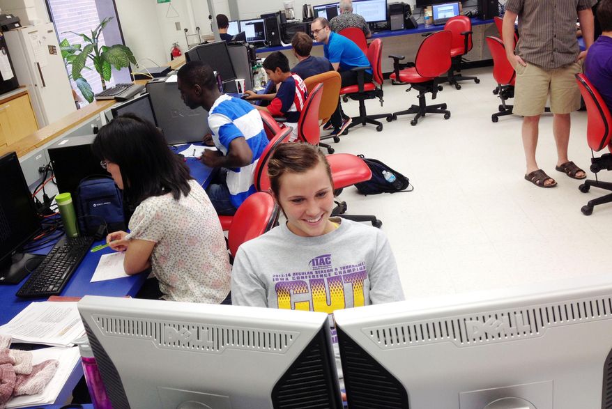 Alexis Hanson, a sophomore from Loras College, works on lab computers July 17, 2014, in the Bowen Science Building at the University of Iowa in Iowa City, Iowa. (AP Photo/Iowa City Press-Citizen, Josh O'Leary) ** FILE **