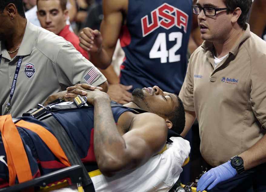 Indiana Pacers' Paul George is taken off the court after he was injured during the USA Basketball Showcase game Friday, Aug. 1, 2014, in Las Vegas. (AP Photo/John Locher)