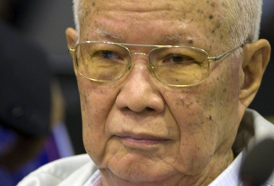 In this photo released by the Extraordinary Chambers in the Courts of Cambodia, Khieu Samphan, the Khmer Rouge's former head of state, sits inside the courtroom of a U.N.-backed war crimes tribunal in Phnom Penh, Cambodia, Thursday, Aug. 7, 2014. Three and a half decades after the genocidal rule of Cambodia's Khmer Rouge ended, the U.N.-backed tribunal on Thursday sentenced Khieu Samphan and Nuon Chea, two top leaders of the former regime, to life in prison for crimes against humanity during the country's 1970s terror period that left close to 2 million people dead. (AP Photo/Extraordinary Chambers in the Courts of Cambodia, Mark Peters)