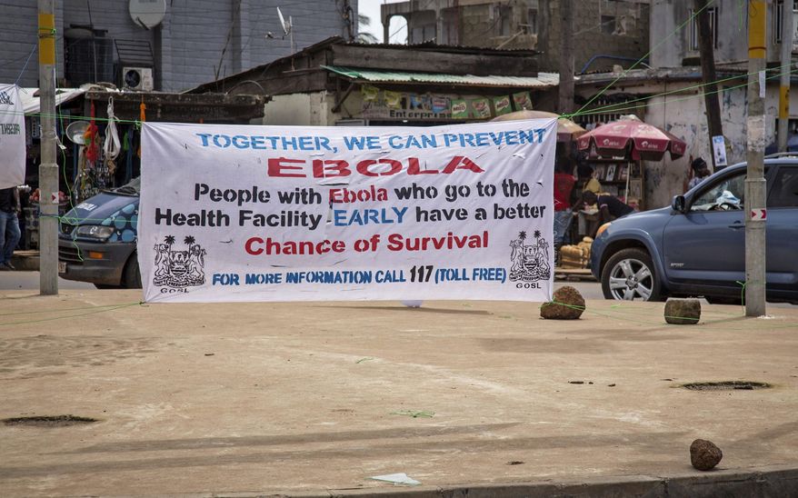 A banner encouraging people suffering from Ebola to go immediately to a health center for treatment is seen on a sidewalk in the city of Freetown, Sierra Leone, Thursday, Aug. 7, 2014. While the Ebola virus outbreak has now reached four countries, Liberia and Sierra Leone account for more than 60 percent of the deaths, according to the World Health Organization. The outbreak that emerged in March has claimed at least 932 lives. (AP Photo/Michael Duff)