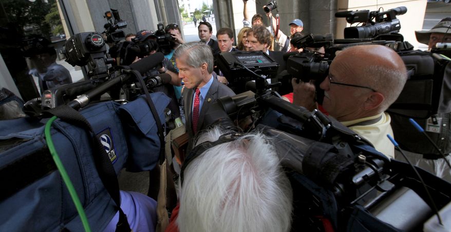 Former Virginia Gov. Bob McDonnell is surrounded by members of the media as he heads into the federal courthouse in Richmond, Va., Thursday, Aug. 7, 2014, where the federal corruption trial of McDonnell and his wife, Maureen continues. The McDonnells are charged with accepting more than $165,000 in gifts and loans from Jonnie Williams, the former CEO of dietary supplements maker Star Scientific Inc., in exchange for helping promote his company's products. (AP Photo/Richmond Times-Dispatch, Bob Brown)