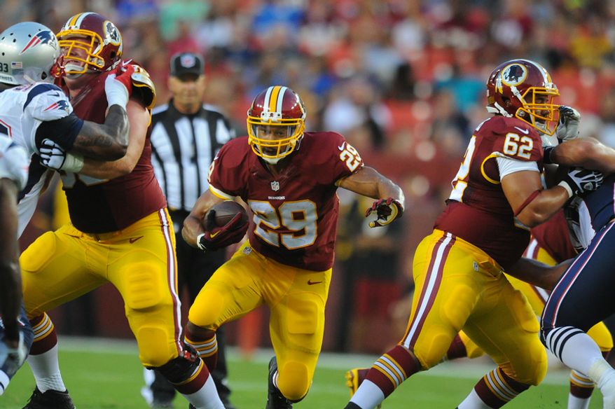Washington Redskins running back Roy Helu (29) runs through the hole during first quarter action against the New England Patriots at FedEx Field, Aug. 7, 2014. (Preston Keres/Special for The Washington Times)