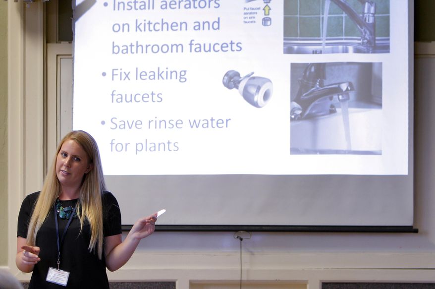 ** FILE ** Amanda Bunte, a representative with the City of Santa Cruz, goes over water conservation tips during Water School at the Louden Nelson Community Center in Santa Cruz, Calif., on Monday, July 14, 2014. Every Monday night in the drought-stricken beach town of Santa Cruz, dozens of residents who violated their strict rations take a seat at Water School, hoping to get hundreds of thousands of dollars in distressing penalties waived. (AP Photo/San Francisco Chronicle, Carlos Avila Gonzalez)