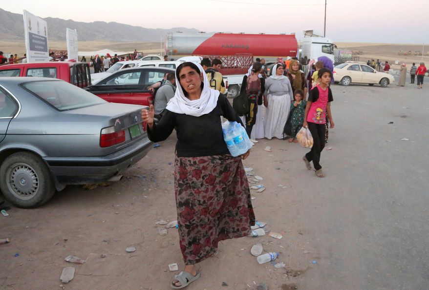 LED IN: Displaced Iraqis from the Yazidi community arrive to the camp of Bajid Kandala at Feeshkhabour town near the Syria-Iraq border, in Iraq Saturday, Aug. 9, 2014. The displacement of at least tens of thousands of Yazidis- Kurdish speakers of an ancient Mesopotamian faith - means yet another Iraqi minority has been peeled away as extremists continue their sweep of Iraq, seizing territory they brutally administer. The Islamic State group fighters already caused the expulsion of Iraqs Christians, Shiite Muslims and adherents of the tiny Shabak faith. The hardliners see other religious groups as heretics who may be killed or forced to submit to their rule. (AP Photo/ Khalid Mohammed)