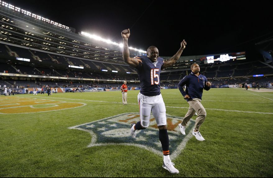 Chicago Bears wide receiver Brandon Marshall runs off the field after the Bears' 20-19 win over the Jacksonville Jaguars in an NFL preseason football game in Chicago, Thursday, Aug. 14, 2014. (AP Photo/Charles Rex Arbogast)