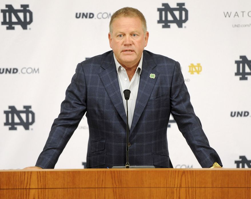 FILE - In this Aug. 1, 2014, file photo, Notre Dame football coach Brian Kelly talks to the media at the beginning of fall practice in South Bend, Ind. Notre Dame says it is investigating "suspected academic dishonesty" involving several students, including four members of the football team. The school released a statement Friday, Aug. 15 saying it has notified the NCAA and that because of potential NCAA violations the four players are being held out of practice and completion until the conclusion of the investigation and the university honor code process. (AP Photo/Joe Raymond, File)