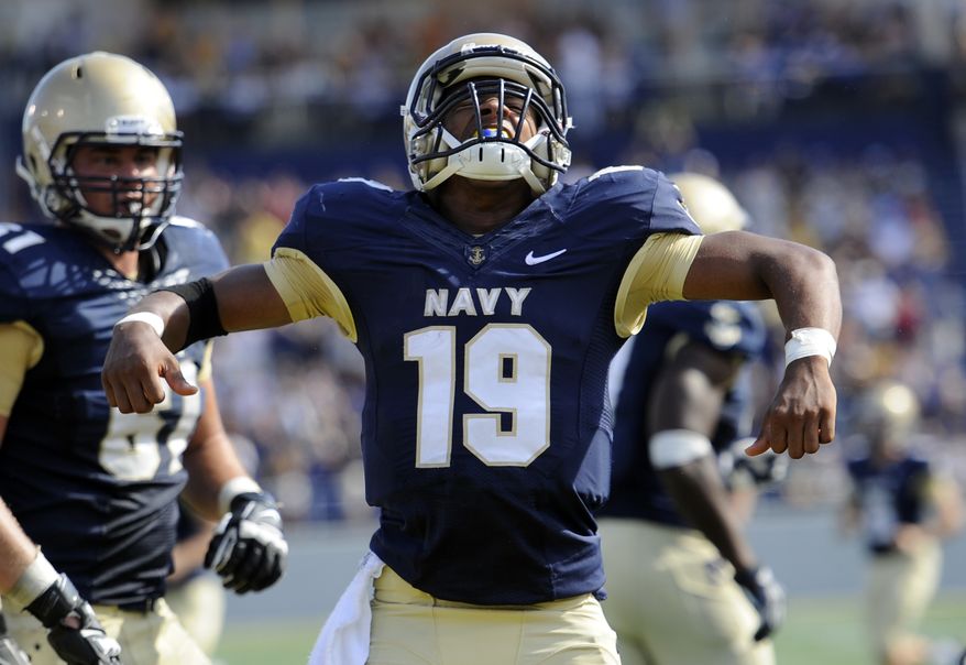 Navy quarterback Keenan Reynolds (19) celebrates after scoring a touchdown during the second half of an NCAA football game against Air Force, Saturday, Oct. 5, 2013, in Annapolis, Md. Navy won 28-10. (AP Photo/Nick Wass)