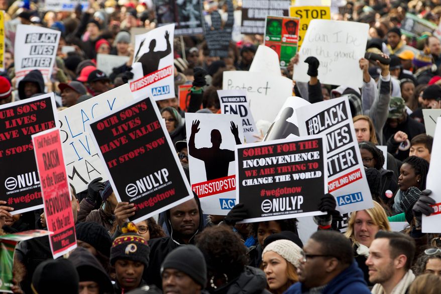 Demonstrators march on Pennsylvania Avenue toward Capitol Hill in Washington, Saturday, Dec. 13, 2014, during the Justice for All march. More than 10,000 protesters are converging on Washington in an effort to bring attention to the deaths of unarmed black men at the hands of police. Civil rights organizations are holding a march to the Capitol on Saturday with the families of Michael Brown and Eric Garner, two unarmed black men who died in incidents with white police officers. (AP Photo/Jose Luis Magana)