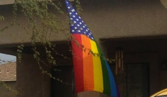 Officials at Davis Monthan Air Force Base, in Tuscon, Arizona, are reportedly allowing a rainbow-striped American flag to remain flying at someone's home after an airman complained it violated Title 4 of the U.S. Code. (Brian Kolfage via The Blaze)