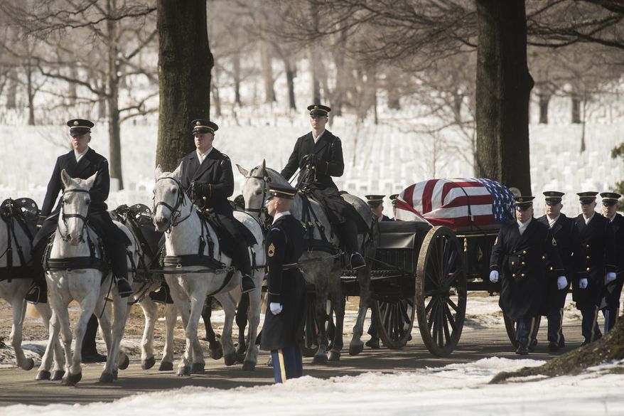 A caisson carries the remains of U.S. Army Air Force Tech Sgt. Charles Johnston, and airman missing from World War II, Monday, March 2, 2015, during burial services at Arlington National Cemetery in Arlington, Va. Johnston died on April 10, 1944 when his B-24 was shot down over New Guinea.  (AP Photo/Kevin Wolf)