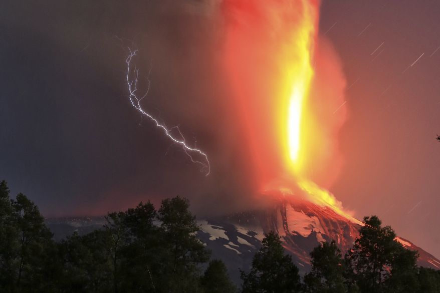 The Villarica volcano erupts near Pucon, Chile, early Tuesday, March 3, 2015. The Villarica volcano erupted Tuesday around 3 a.m. local time (0600 GMT), according to the National Emergency Office, which issued a red alert and ordered evacuations. (AP Photo/ Aton Chile)
