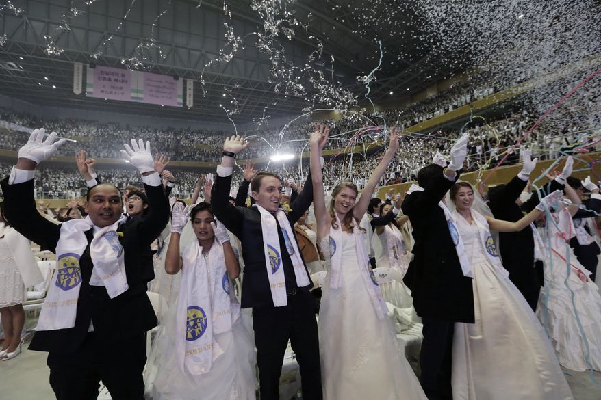 Couples from around the world celebrate after a mass wedding ceremony at the Cheong Shim Peace World Center in Gapyeong, South Korea, Tuesday, March 3, 2015. Some 3,800 South Korean and foreign couples exchanged or reaffirmed marriage vows in the Unification Church&#39;s mass wedding arranged by Hak Ja Han Moon, wife of the late Rev. Sun Myung Moon, the controversial founder of the Unification Church. (AP Photo/Ahn Young-joon)