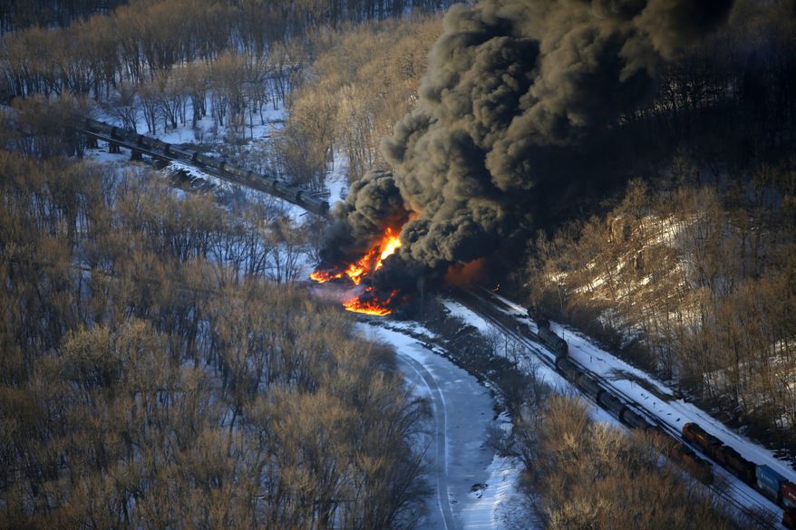 Smoke and flames erupt from the scene of a train derailment Thursday, March 5, 2015, near Galena, Ill. A BNSF Railway freight train loaded with crude oil derailed around 1:20 p.m. in a rural area where the Galena River meets the Mississippi, said Jo Daviess County Sheriff&#39;s Sgt. Mike Moser. (AP Photo/Telegraph Herald, Mike Burley)