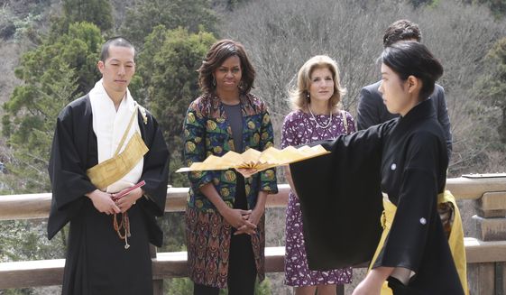 U.S. first lady Michelle Obama, second from left, watches a Noh performance by local college students, with monk of Kiyomizu-dera Buddhist temple, Eigen Onishi, left, U.S. Ambassador to Japan Caroline Kennedy, second from right,  at the temple in Kyoto, western Japan, Friday, March 20, 2015. Noh is a form of classical Japanese musical drama. Kiyomizu-dera is a UNESCO World Heritage site and one of Kyoto's most famous vistas. (AP Photo/Koji Sasahara)