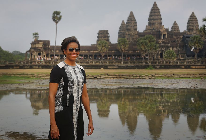 U.S. first lady Michelle Obama, takes a tour of Cambodia's famed Angkor Wat temple complex Saturday, March 21, 2015, in Siem Reap, Cambodia. Mrs. Obama on Saturday urged Cambodian students to stay in school and take advantage of their education to demand greater freedoms and more equality in their Southeast Asian country. (AP Photo/Wong Maye-E)