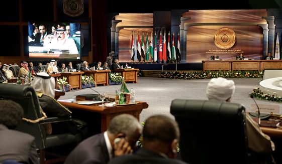 Arab heads of state meet as King Hamad bin Isa Al Khalifa of Bahrain, seen on screen, speaks, in Sharm el-Sheikh, Egypt. Embattled Yemeni President Abdel Rabbo Mansour Hadi called Shiite rebels who forced him to flee the country &quot;stooges of Iran,&quot; directly blaming the Islamic republic for the chaos there and demanding that airstrikes against rebel positions continue until they surrender. Saudi King Salman has vowed that the military intervention in Yemen will not stop until the country is stable. (Associated Press)