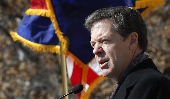 In this Jan. 22, 2013 file photo, Kansas Republican Gov. Sam Brownback speaks during a pro-life rally outside the Kansas Statehouse in Topeka, Kan. Brownback, a strong abortion opponent, signed a bill Tuesday, April 7, 2015 making Kansas the first state to ban a common second-trimester abortion procedure that critics describe as dismembering a fetus. (AP Photo/Orlin Wagner/File)