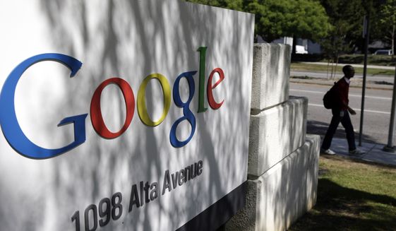 FILE - In this June 5, 2014 file photo, a man walks past a Google sign at the company's headquarters in Mountain View, Calif. Google may have to pay more than half a billion dollars for an unorthodox stock split aimed at ensuring co-founders Larry Page and Sergey Brin retain control over the Internet's most profitable company. (AP Photo/Marcio Jose Sanchez, File)