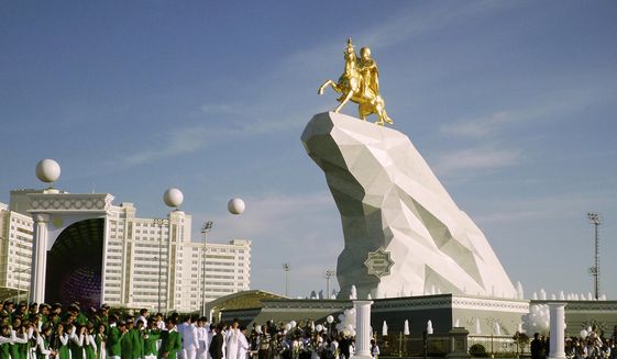 People gather for the monument unveiling ceremony in Ashgabat, Turkmenistan Monday, May 25, 2015. (AP Photo/Alexander Vershinin)