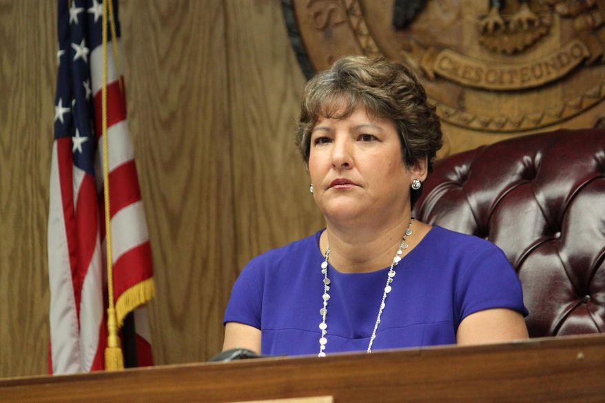 New Mexico Public Regulation Commission Chairwoman Karen Montoya listens to debate on whether to give Public Service Co. of New Mexico more time to reach agreements with a coal company during the commission's meeting in Santa Fe, N.M., on Wednesday, May 27, 2015. The commission voted 4-1 to give the utility until Aug. 31 to reach final agreements with the company, delaying a decision that will affect the future of the San Juan Generating Station. (AP Photo/Susan Montoya Bryan)