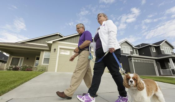 Amy Shives, right, and her husband George walk their cavalier King Charles spaniel Chester in their neighborhood, Wednesday, June 3, 2015, in Spokane, Wash. Amy Shives was diagnosed with early onset Alzheimer&#39;s disease in 2011 and has since been involved with the Alzheimer&#39;s Association. Nearly two-thirds of Americans with Alzheimer&#39;s disease are women, and now some scientists are questioning the long-held assumption that it&#39;s just because women tend to live longer than men. (AP Photo/Young Kwak)