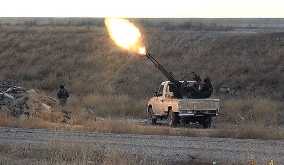 Islamic State militants open fire toward a Syrian warplane in the predominantly Kurdish Syrian city of Hassakeh, Syria. (Associated Press)