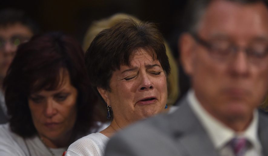 Liz Sullivan, mother of Kathryn Steinle, is consoled by Sabine Durden as she cries during the testimony of Kathryn's father Jim Steinle during a Senate Judiciary hearing in Washington on Tuesday. The family told Congress they support changing the laws that allowed her alleged killer to remain in the United States despite being deported several times. (Associated Press)
