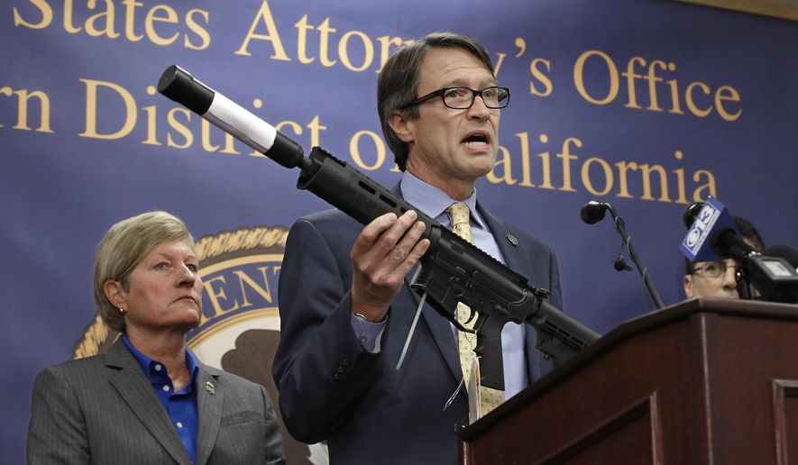 Benjamin Wagner, the United States Attorney for the Eastern District of California, displays one of the guns seized in an undercover operation, during a news conference in Sacramento, Calif., on Oct. 15, 2015. Wagner announced a federal grand jury indicted 8 men on a variety of firearm charges including the manufacturing and dealing in firearms without a license.  At left is Jill A. Snyder, Special Agent in Charge for the Bureau of Alcohol, Tobacco, Firearms and Explosives. (Associated Press) **FILE**