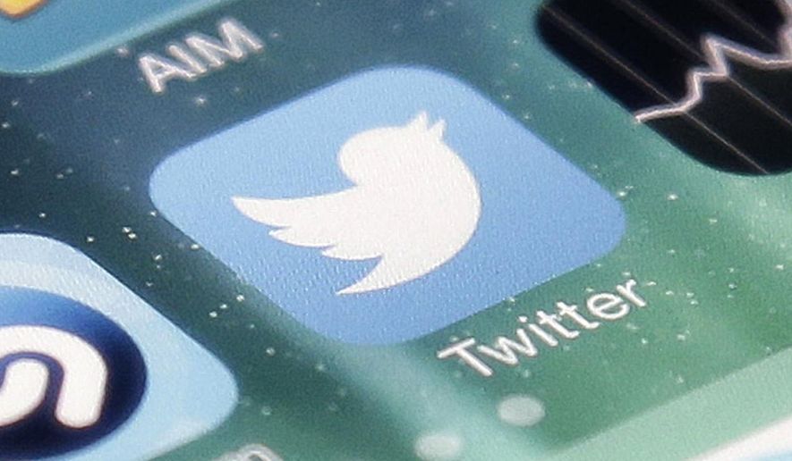 This Nov. 4, 2013, file photo shows the icon for the Twitter app on an iPhone in San Jose, Calif. (AP Photo/Marcio Jose Sanchez, File)
