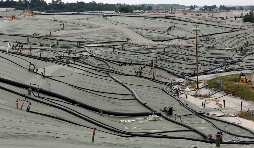 This photo taken Aug. 28, 2015 shows a membrane covering hundreds of feet of garbage and various pipes that direct leachate to a treatment plant at the Bridgeton Landfill in Bridgeton, Mo. The Environmental Protection Agency on Thursday, Dec. 10, 2015, ordered surface fire prevention measures at the St. Louis-area landfill where nuclear waste was illegally dumped four decades ago. (Huy Mach/The St. Louis Post Dispatch via AP)