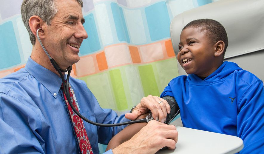 In this photo provided by the University of Virginia Health System, taken Dec. 9, 2015, Marshall Jones, right, laughs with Dr. John Barcia in the Battle Building at the University of Virginia Children&#39;s Hospital in Charlottesville, Va. A shake-up of the nation&#39;s kidney transplant system is getting more organs to patients once thought nearly impossible to match, according to early tracking of the new rules. (Coe Sweet/UVA Health System via AP) MANDATORY CREDIT