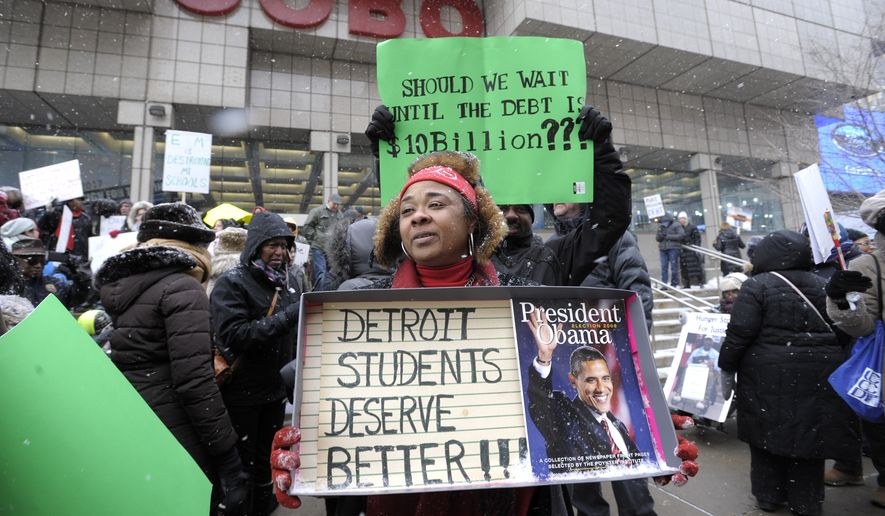 Western International High School teacher Debrah Baskin, 53, of Southfield, and other teachers from Detroit area schools protest outside the Cobo Center, in this Wednesday, Jan. 20, 2106, file photo, only hours before President Obama&#39;s visit to the auto show. (Todd McInturf/Detroit News via AP) ** FILE *