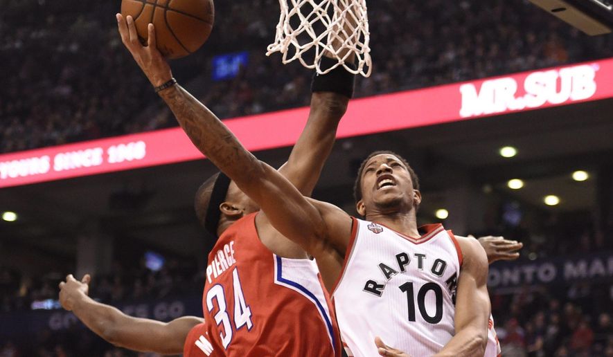 Toronto Raptors&#39; DeMar DeRozan drives to the basket against Los Angeles Clippers&#39; Paul Pierce during first half NBA basketball action in Toronto on Sunday, Jan. 24, 2016. (Frank Gunn/The Canadian Press via AP)