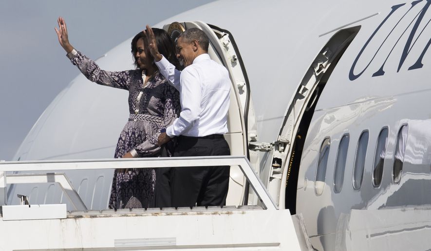 U.S. President Barack Obama and his wife, First Lady Michelle Obama, wave from the door of Air Force One, as they depart from the International Buenos Aires airport on their way to the resort town of Bariloche, Argentina, Thursday, March 24, 2016. Obama is closing his two-day visit to Argentina by spending the afternoon with his family in Bariloche, a picturesque city in southern Argentina, before departing for Washington. (AP Photo/Ivan Fernandez)