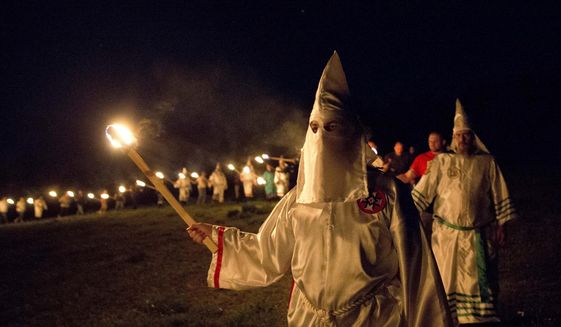 In this Saturday, April 23, 2016 photo, members of the Ku Klux Klan participate in cross burnings after a &amp;quot;white pride&amp;quot; rally in rural Paulding County near Cedar Town, Ga. (AP Photo/John Bazemore)