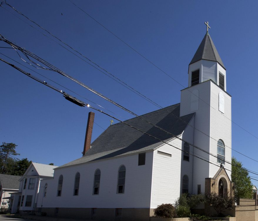In this photo taken Thursday Aug. 4, 2016 the Saint Stanislaus parish in seen in Nashua, N.H. The newly-reopened Saint Stanislaus parish will celebrate its first Mass on Sunday, August 7, with Reverend John Brancich. The parish is set to become the first New England be dedicated to Latin Mass. (AP Photo/Jim Cole)