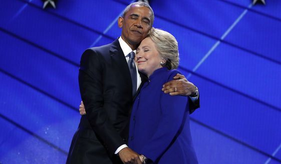 President Barack Obama hugs Democratic Presidential candidate Hillary Clinton after addressing the delegates during the third day session of the Democratic National Convention in Philadelphia, Wednesday, July 27, 2016. (AP Photo/Carolyn Kaster)
