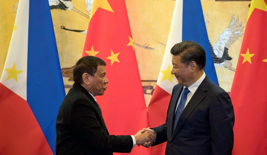 Philippine President Rodrigo Duterte (left) received a warm welcome from Chinese President Xi Jinping on Thursday. Mr. Duterte&#39;s visit is part of a charm offensive aimed at seeking trade and support from the Asian giant by setting aside a territorial dispute. (Associated Press)
