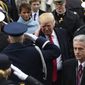 President Donald Trump salutes military personnel as he leaves Capitol Hill in Washington, Friday, Jan. 20, 2017, after taking the presidential oath. (Saul Loeb/Pool Photo via AP)