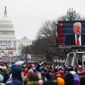 President Donald Trump is seen speaking on video monitor on the National Mall during his inauguration, Friday, Jan. 20, 2017, in Washington. (AP Photo/John Minchillo)