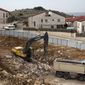 Heavy machinery work at a construction site in the West Bank Jewish settlement of Ariel, Wednesday, Jan. 25, 2017. Israel announced plans Tuesday to build 2,500 more settler homes on the West Bank, moving to step up construction just days after the swearing-in of Donald Trump brought to power a U.S. administration seen as friendly to the settlement movement. (AP Photo/Ariel Schalit)