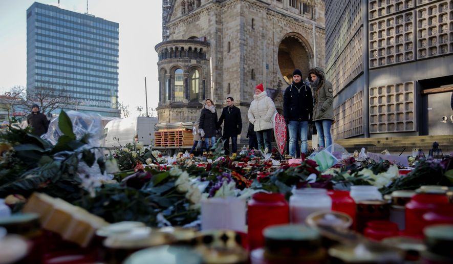 Victims of terrorist attacks were remembered in Paris, Berlin and Germany after Islamic State operatives infiltrated refugee flows. President Trump has placed a 120-day ban on immigration from what he considers high-risk Muslim-majority countries. (Associated Press)