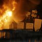 Protestors watch a fire on Sproul Plaza during a rally against the scheduled speaking appearance by Breitbart News editor Milo Yiannopoulos on the University of California at Berkeley campus on Wednesday, Feb. 1, 2017, in Berkeley, Calif. The event was cancelled due to size of the crowd and several fires being set. (AP Photo/Ben Margot)