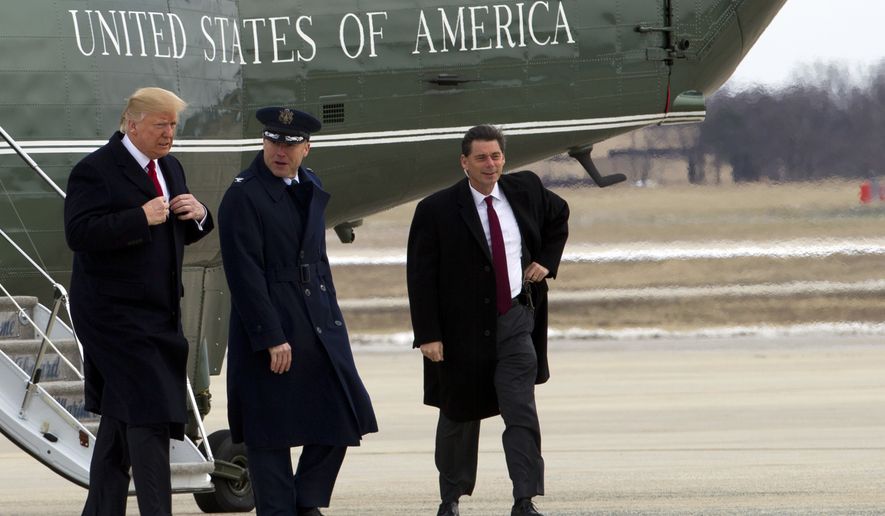 President Donald Trump, escorted by Commander of the 89th Airlift Wing Col. Casey D. Eaton, walks from Marine One to board Air Force One upon his arrival at Andrews Air Force Base, Md., Wednesday, March 15, 2017, en route to Michigan and Tennessee and returning to Washington later this evening. ( AP Photo/Jose Luis Magana)
