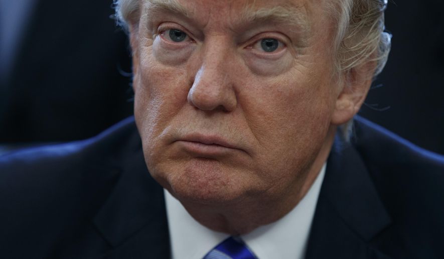 President Donald Trump pauses in the Oval Office of the White House in Washington Friday, March 24, 2017, during an announcement on the approval of a permit to build the Keystone XL pipeline, clearing the way for the $8 billion project. (AP Photo/Evan Vucci)